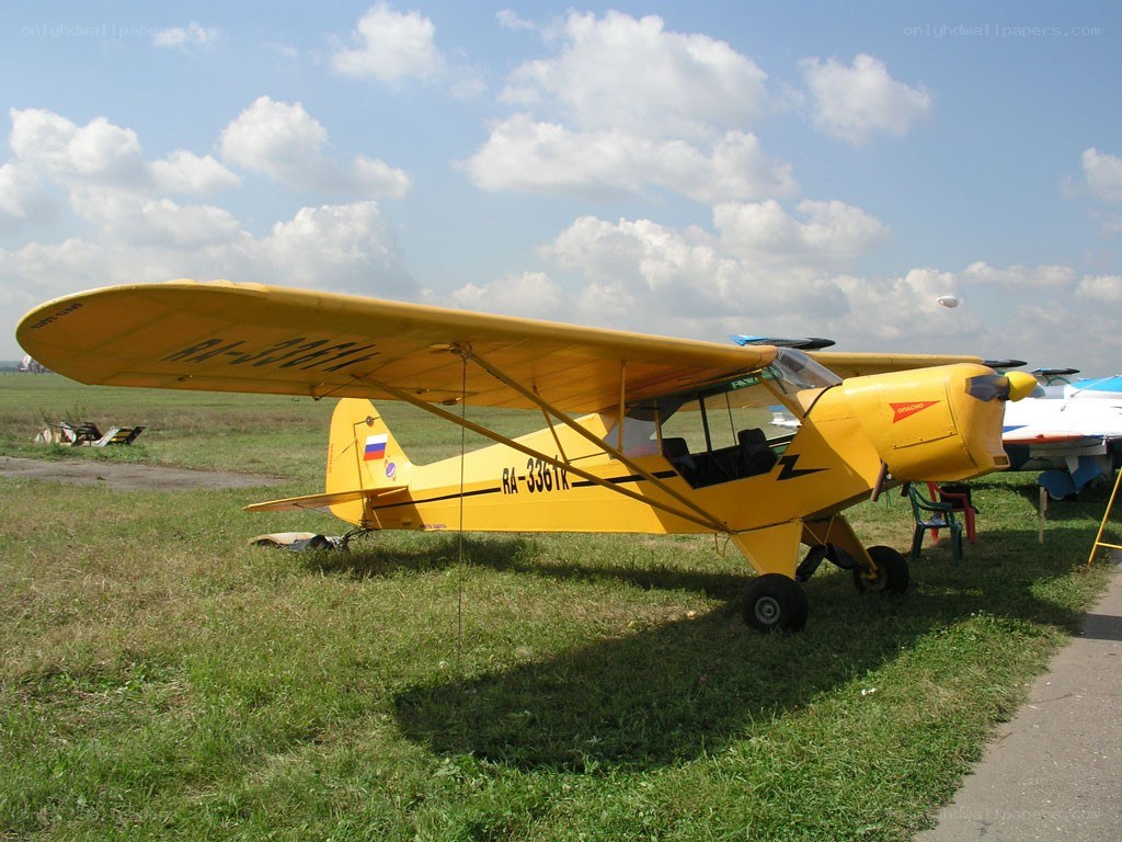 Yellow airplane on grass field
