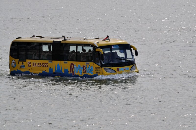 Yellow amphibious tour bus on river