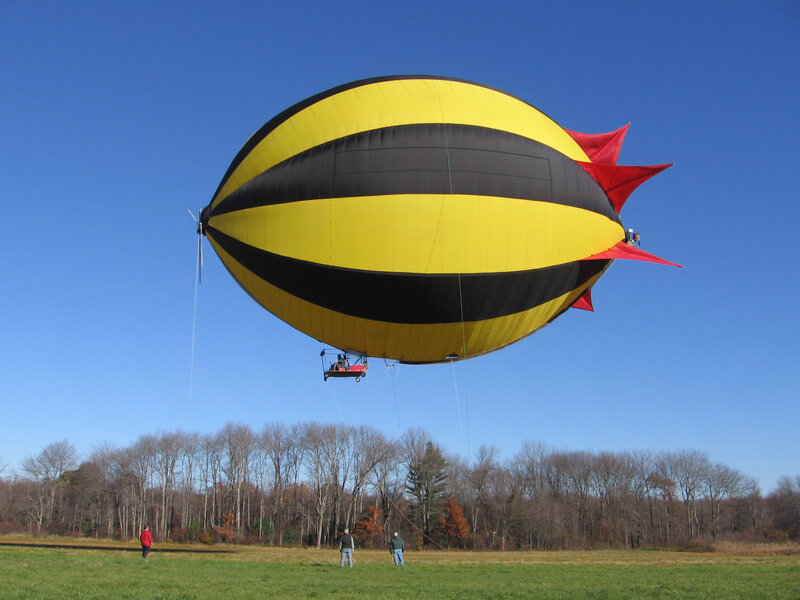 Yellow and black airship in field