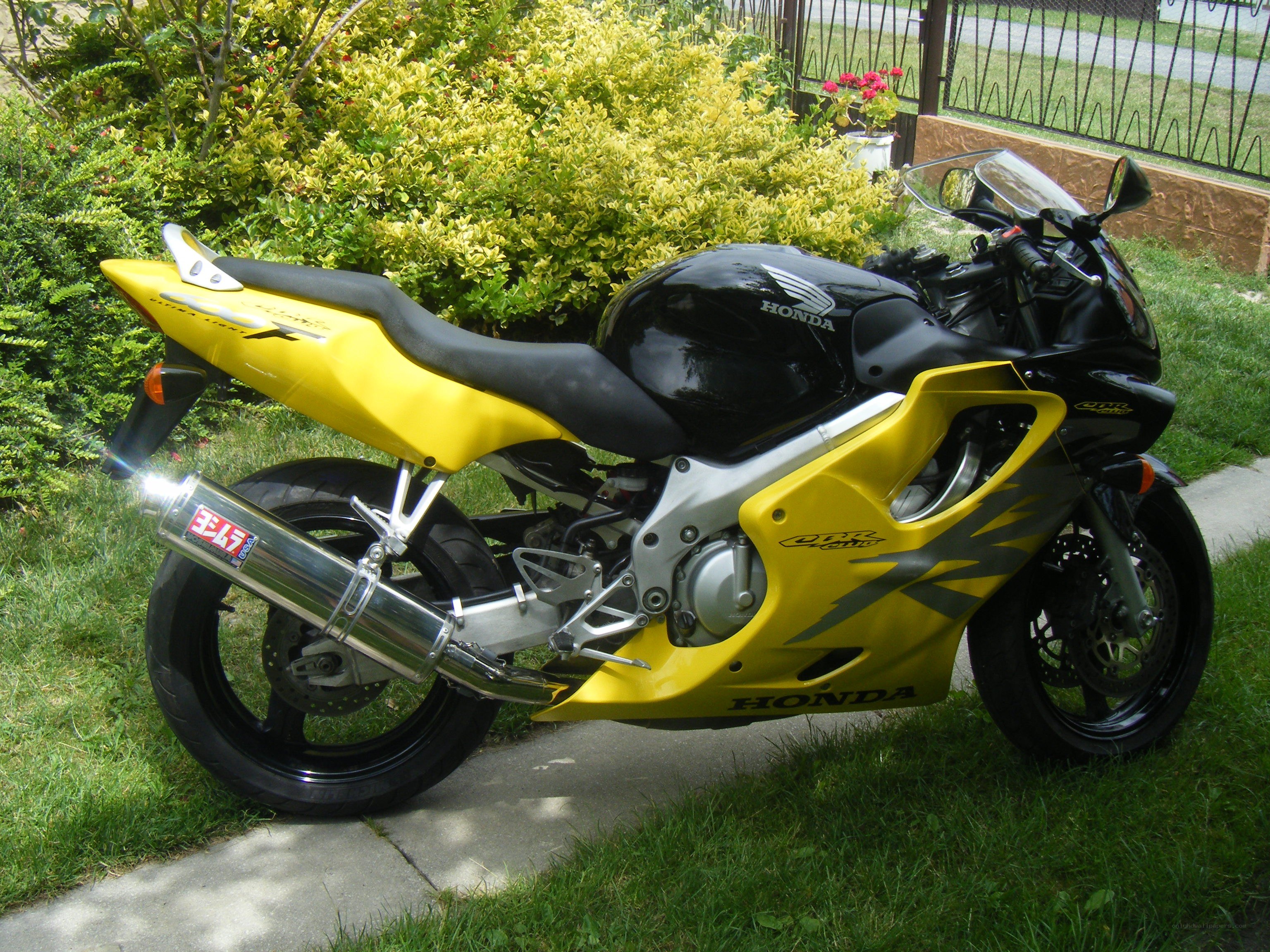 yellow and black Honda motorcycle