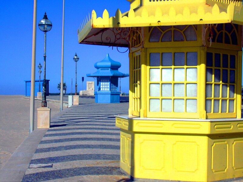 Yellow and blue kiosks on a boardwalk