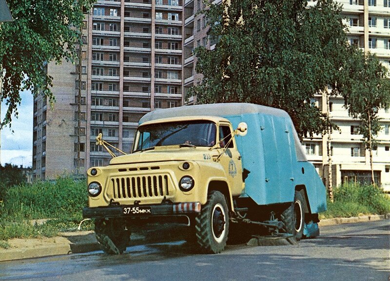 Yellow and blue truck on city street