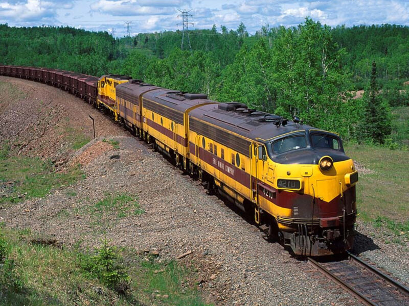 Yellow and maroon train on tracks
