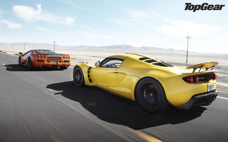 Yellow and orange supercars on a desert road