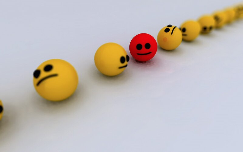 yellow and red emoji balls in line