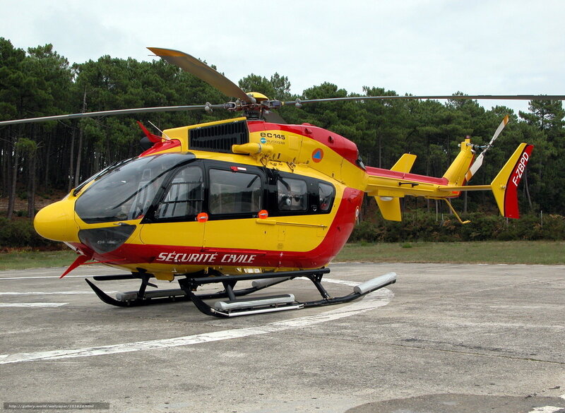 Yellow and red helicopter on tarmac