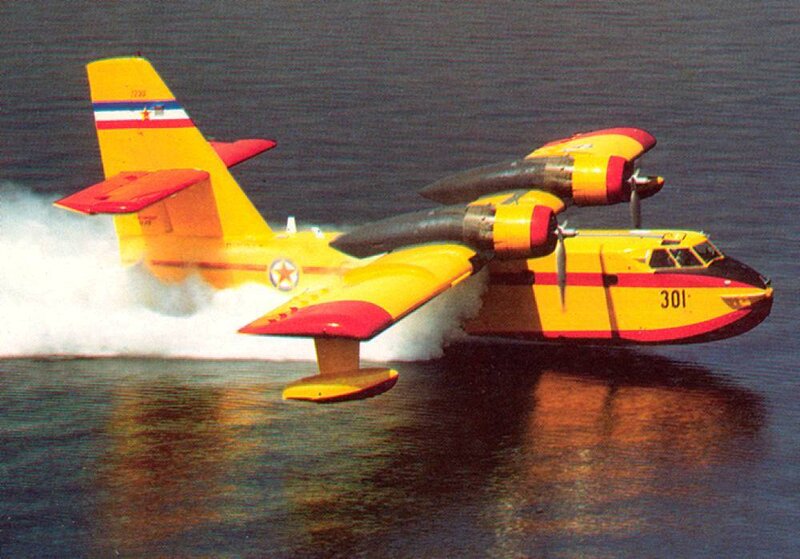 Yellow and red seaplane on water