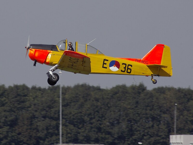 Yellow and red training aircraft in flight