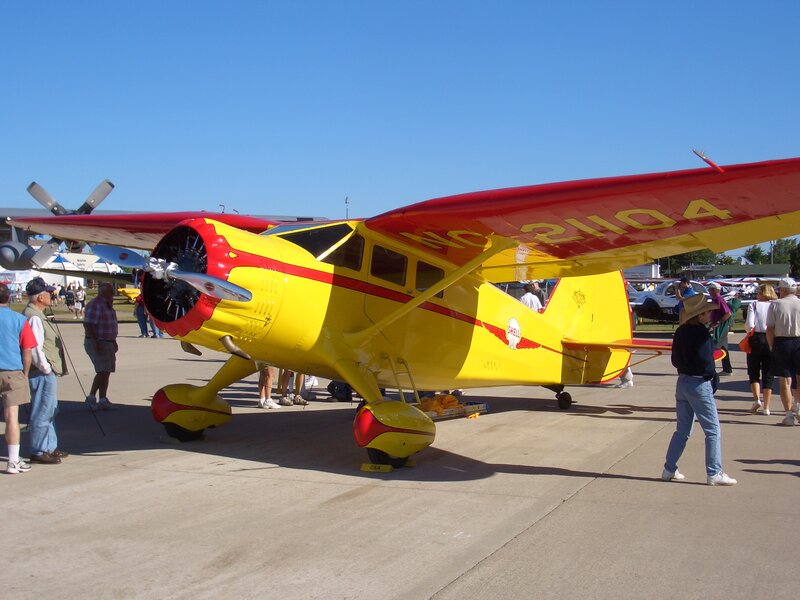 Yellow and red vintage airplane on display