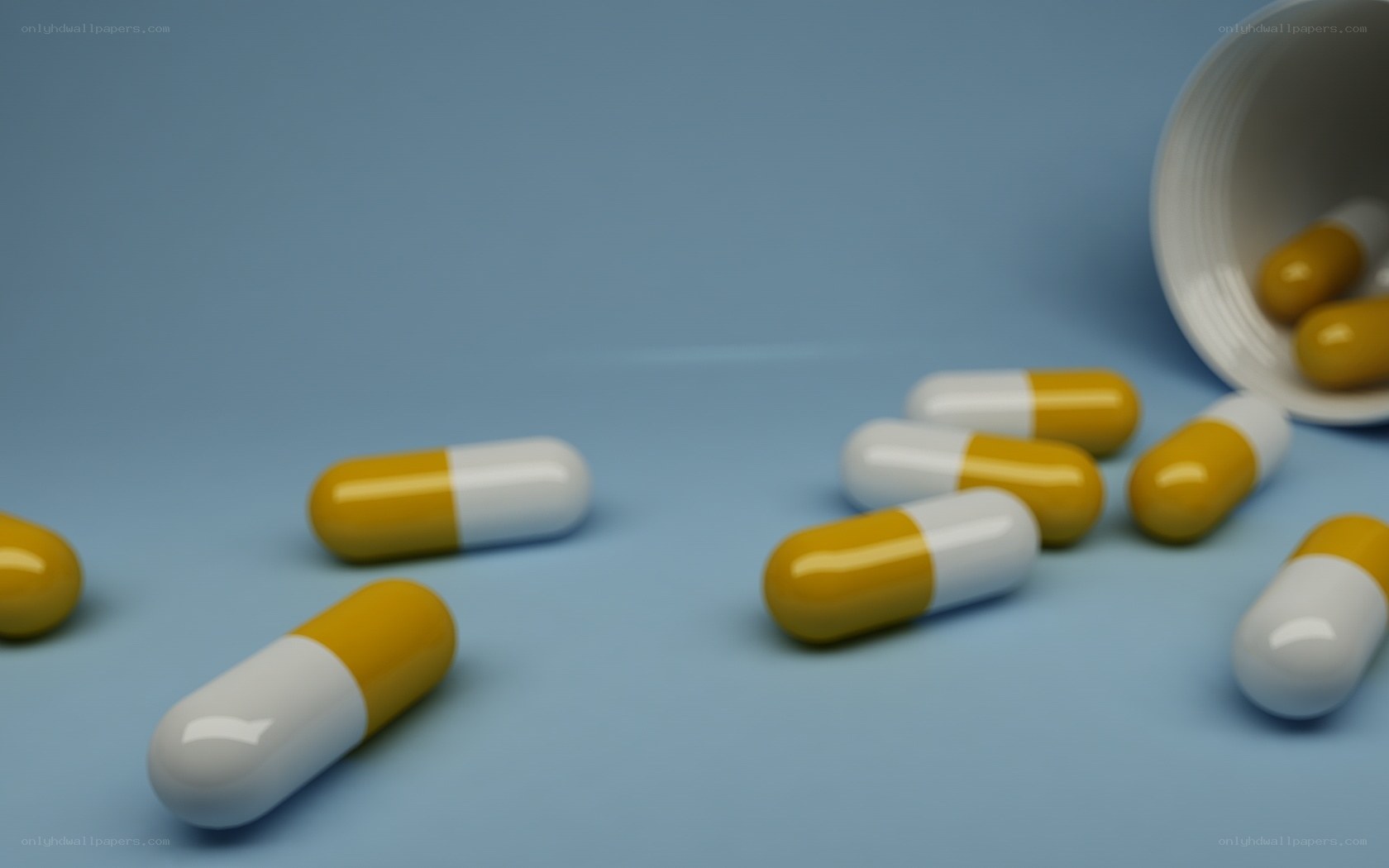 Yellow and white capsules on blue