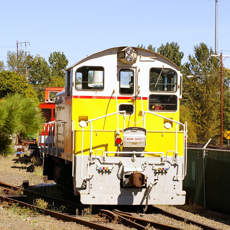 Yellow and white locomotive on tracks