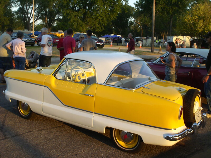 Yellow and white vintage car at a show