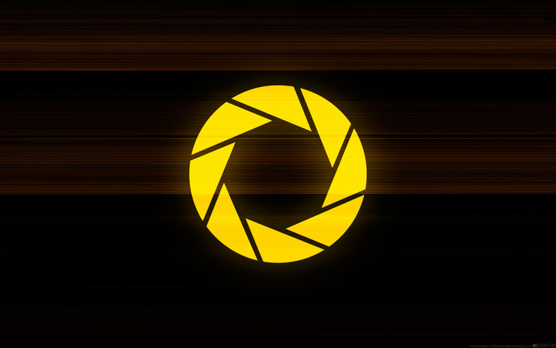 yellow aperture logo on dark background