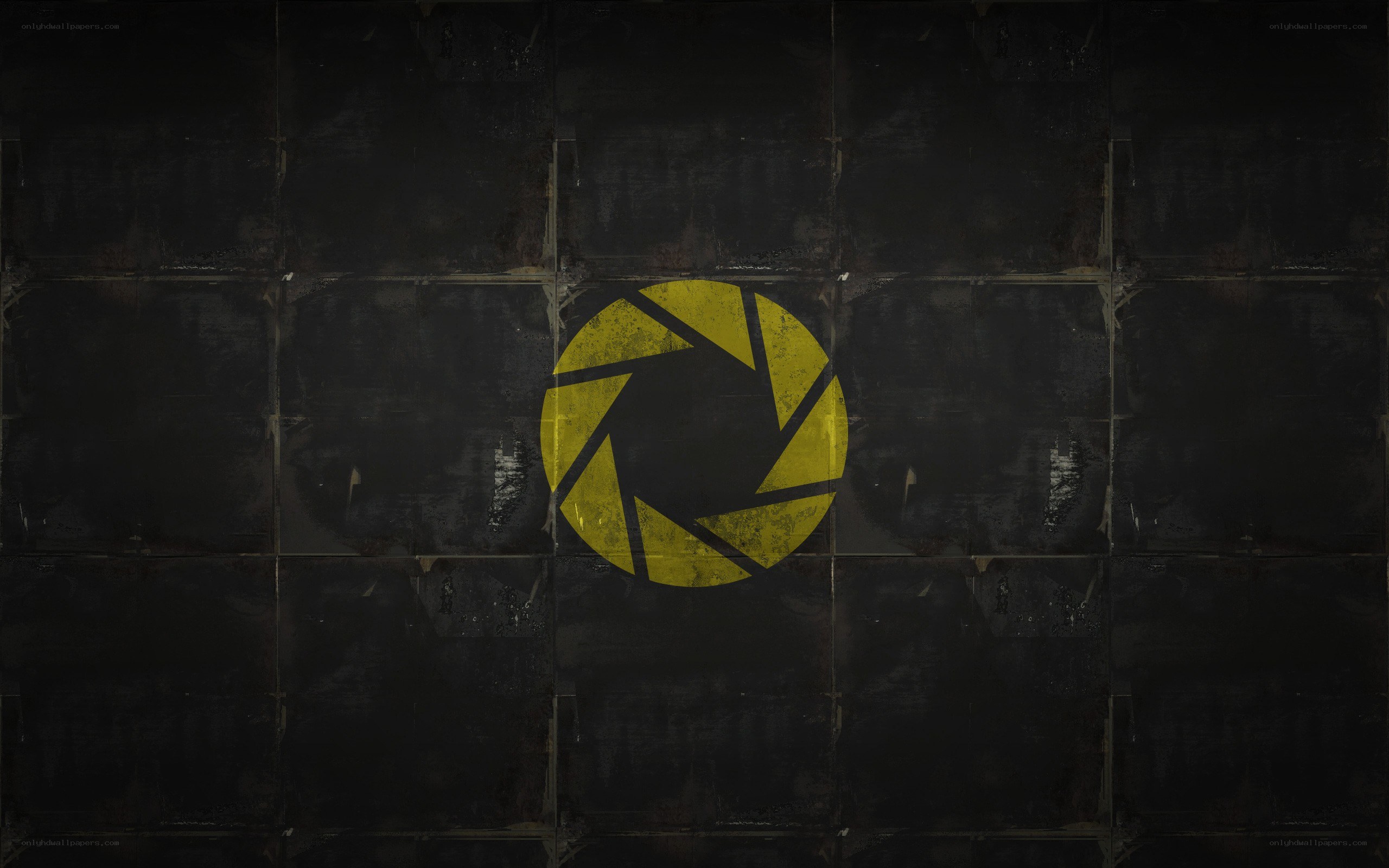 yellow aperture logo on dark wall