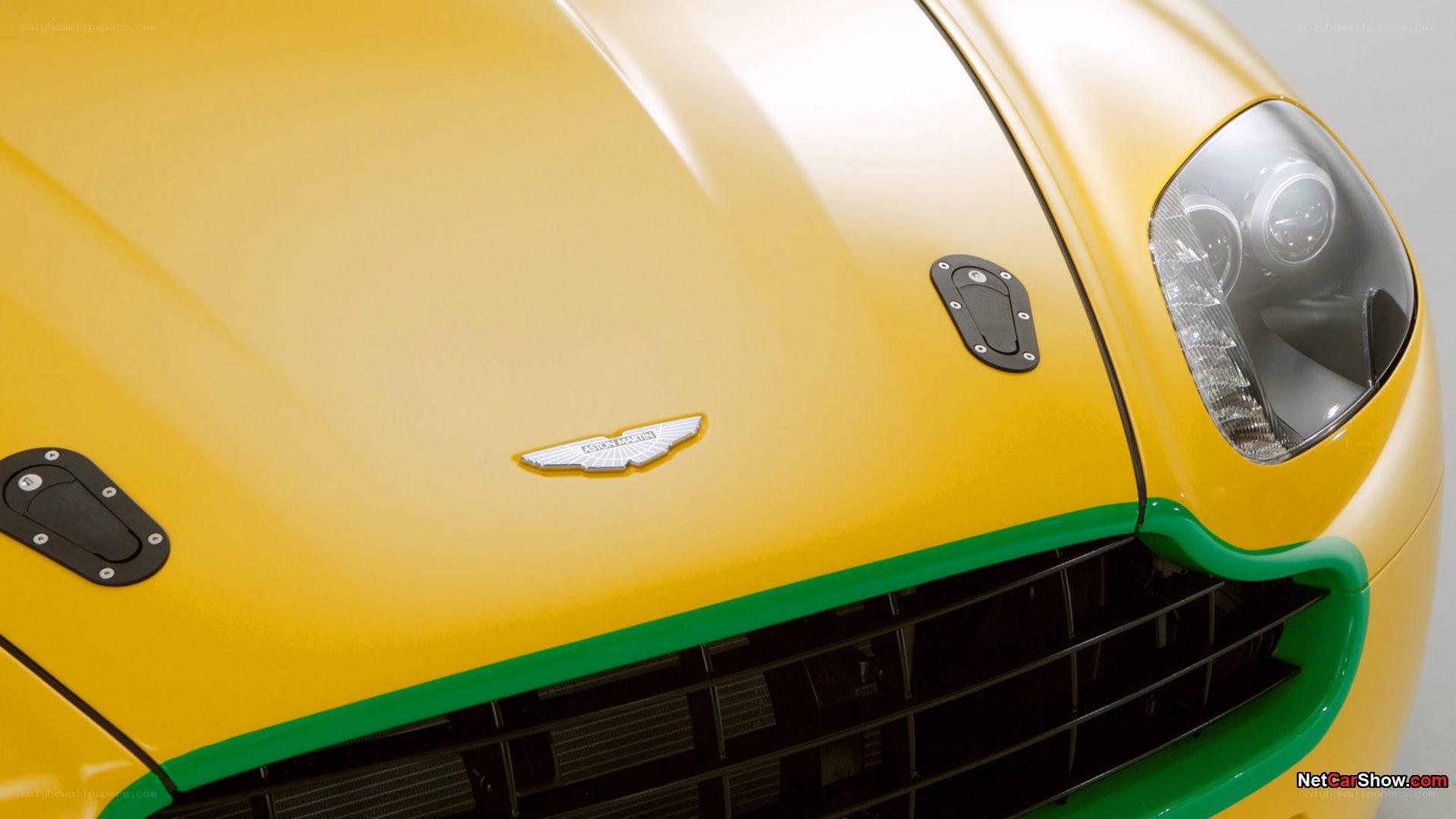 yellow aston martin front view