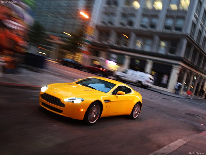 Yellow Aston Martin on city street