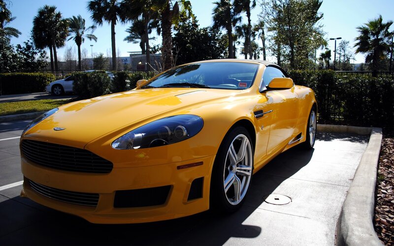 Yellow Aston Martin parked outside