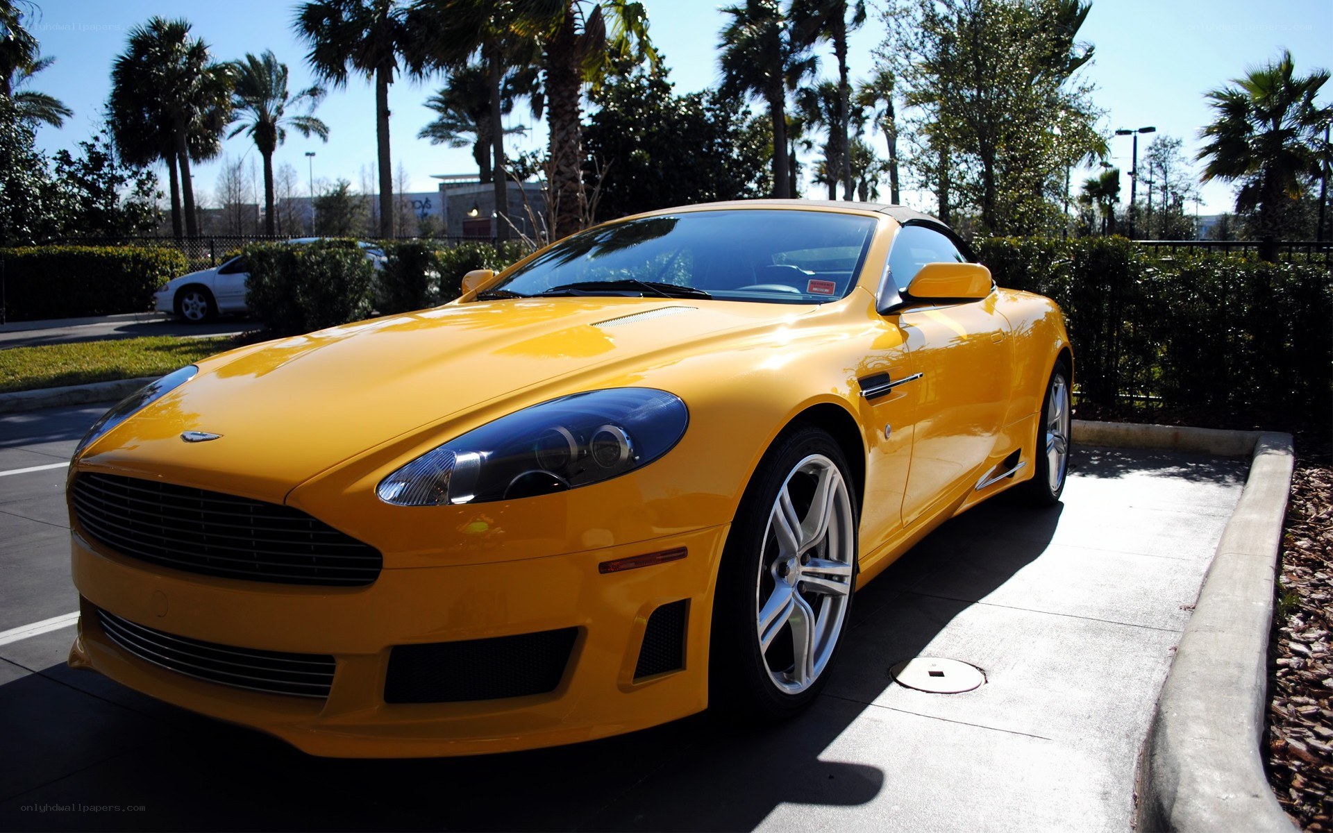 Yellow Aston Martin parked outside