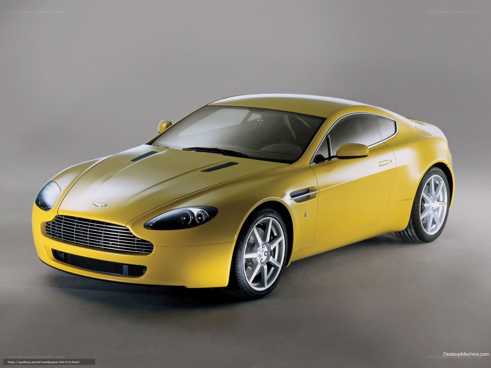 yellow aston martin sports car