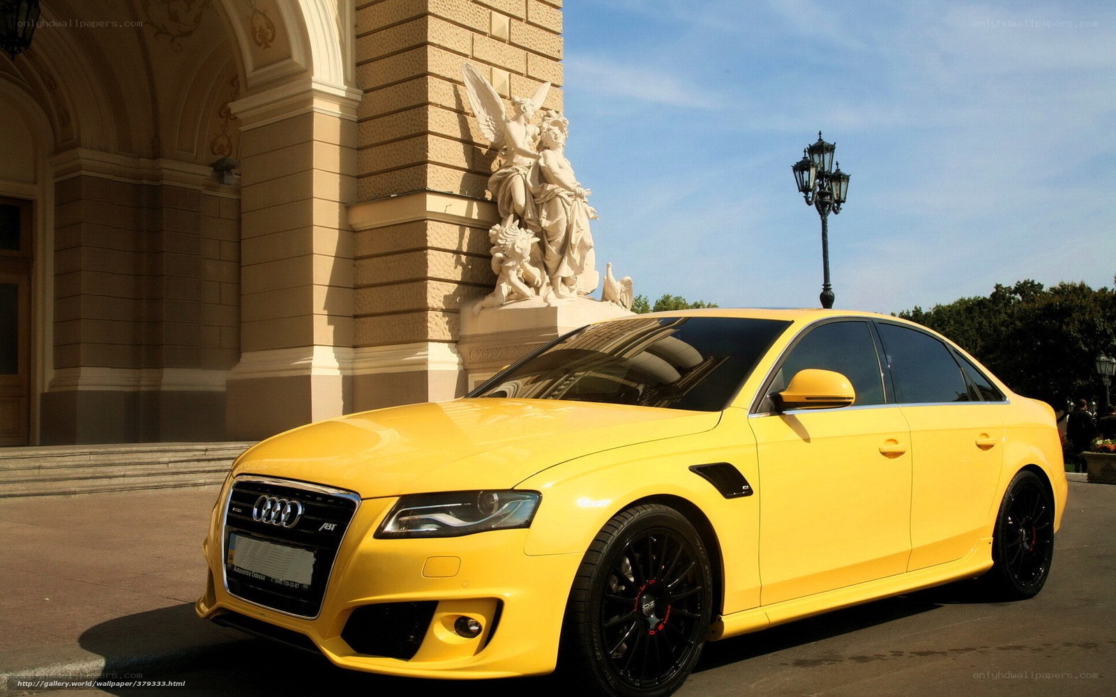 Yellow Audi A4 parked outside building