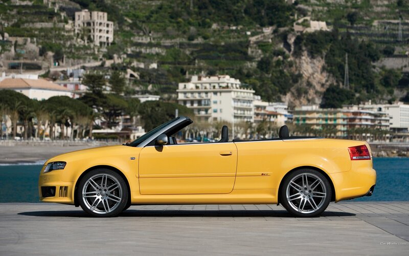 yellow audi convertible by the sea
