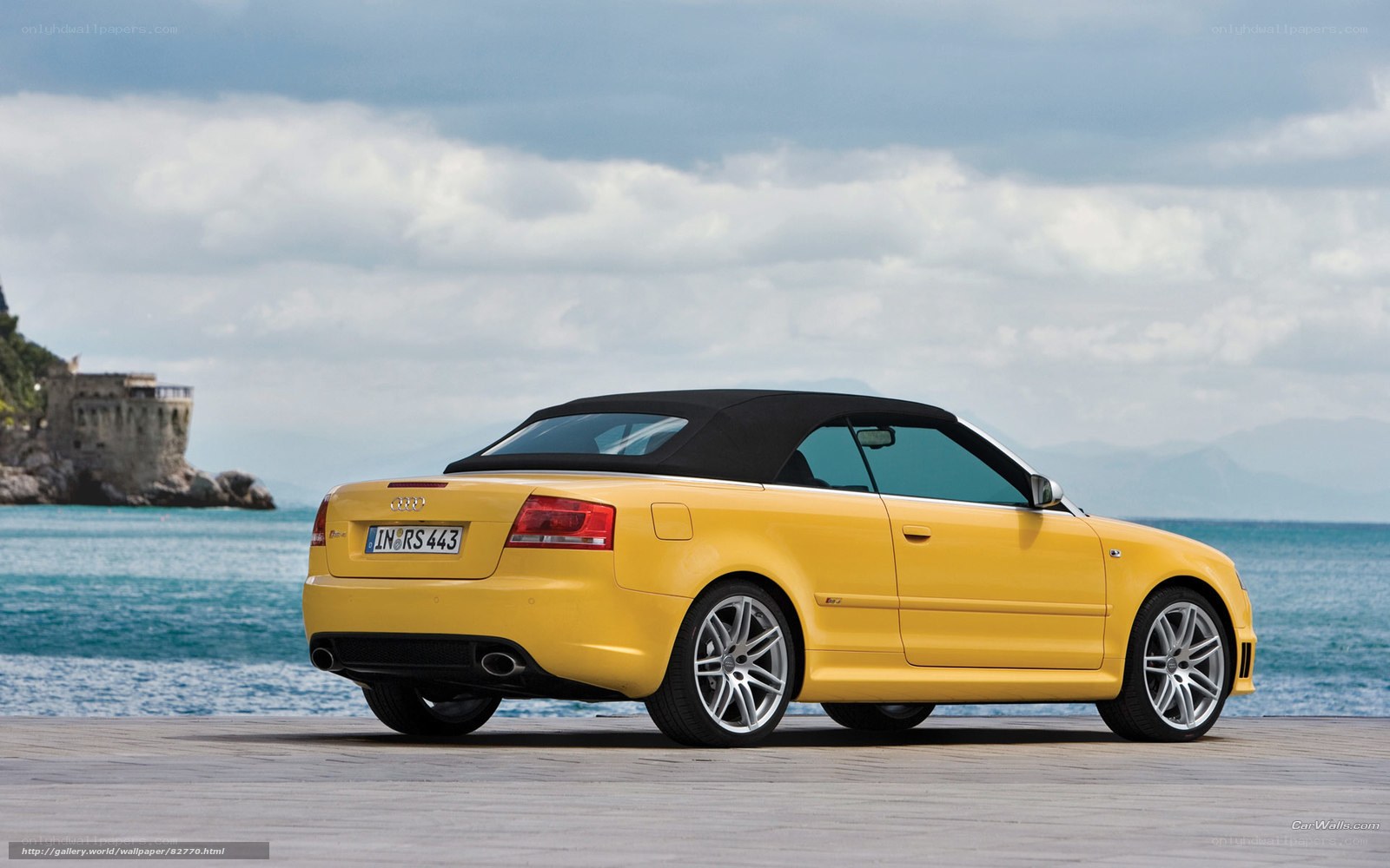 Yellow Audi convertible by the sea