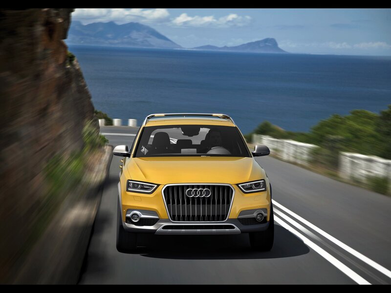 Yellow Audi driving on coastal road