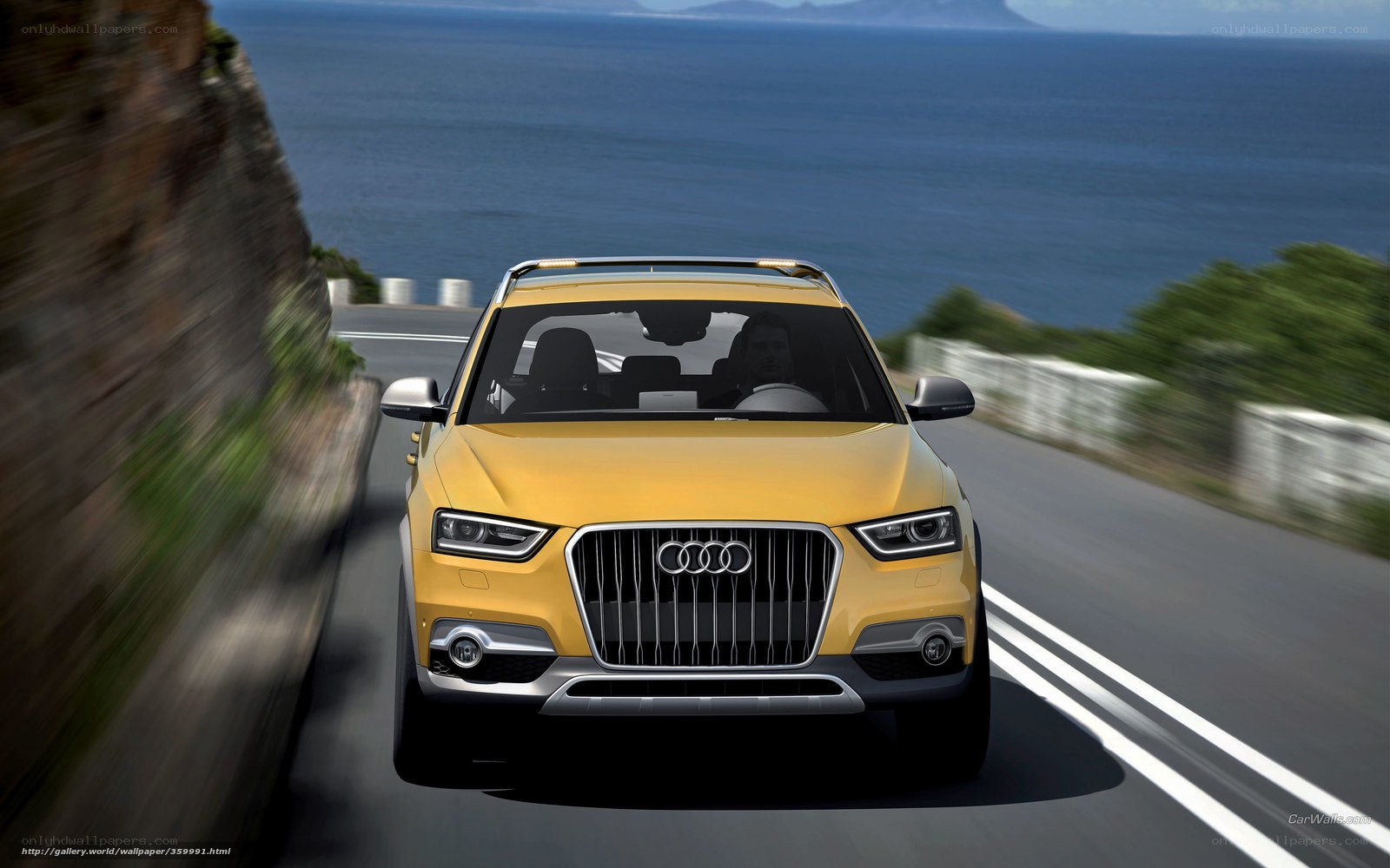 Yellow Audi driving on coastal road