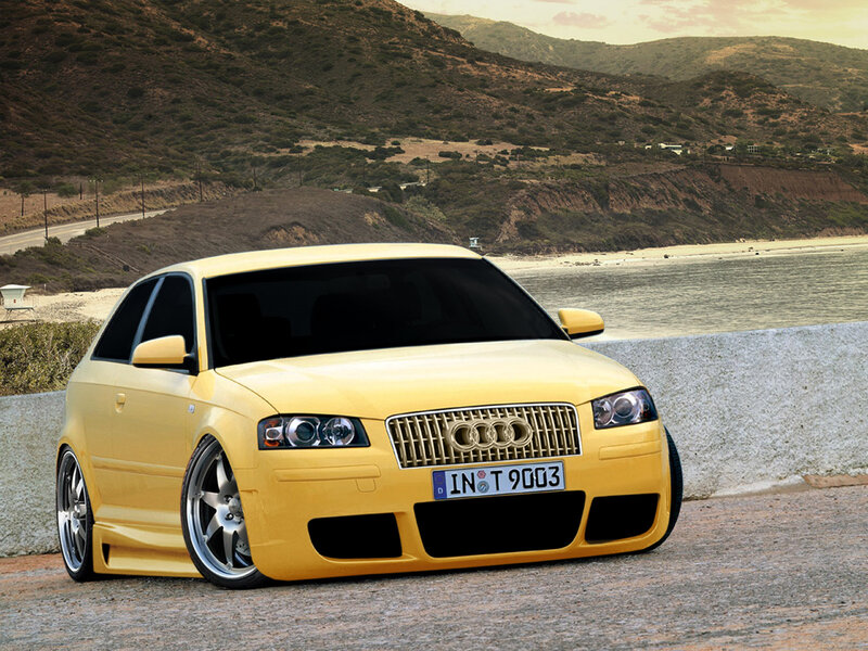 Yellow Audi on coastal road