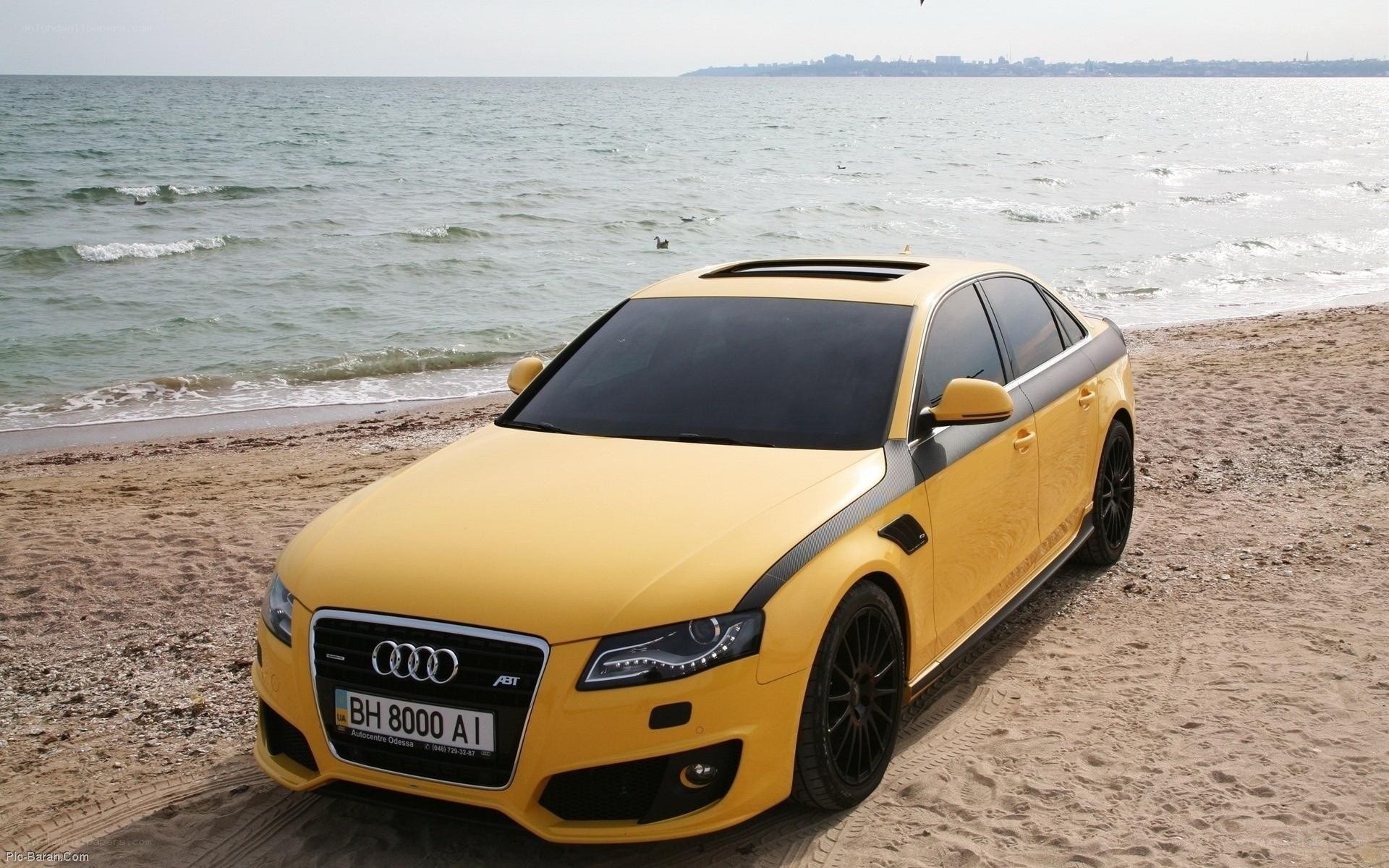 Yellow Audi on the beach