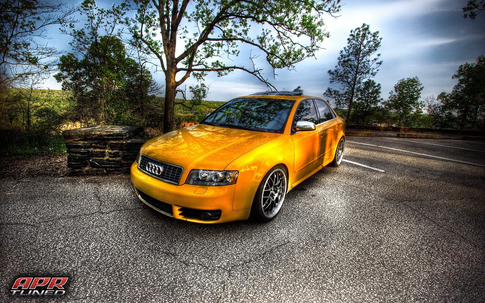 Yellow Audi parked on road