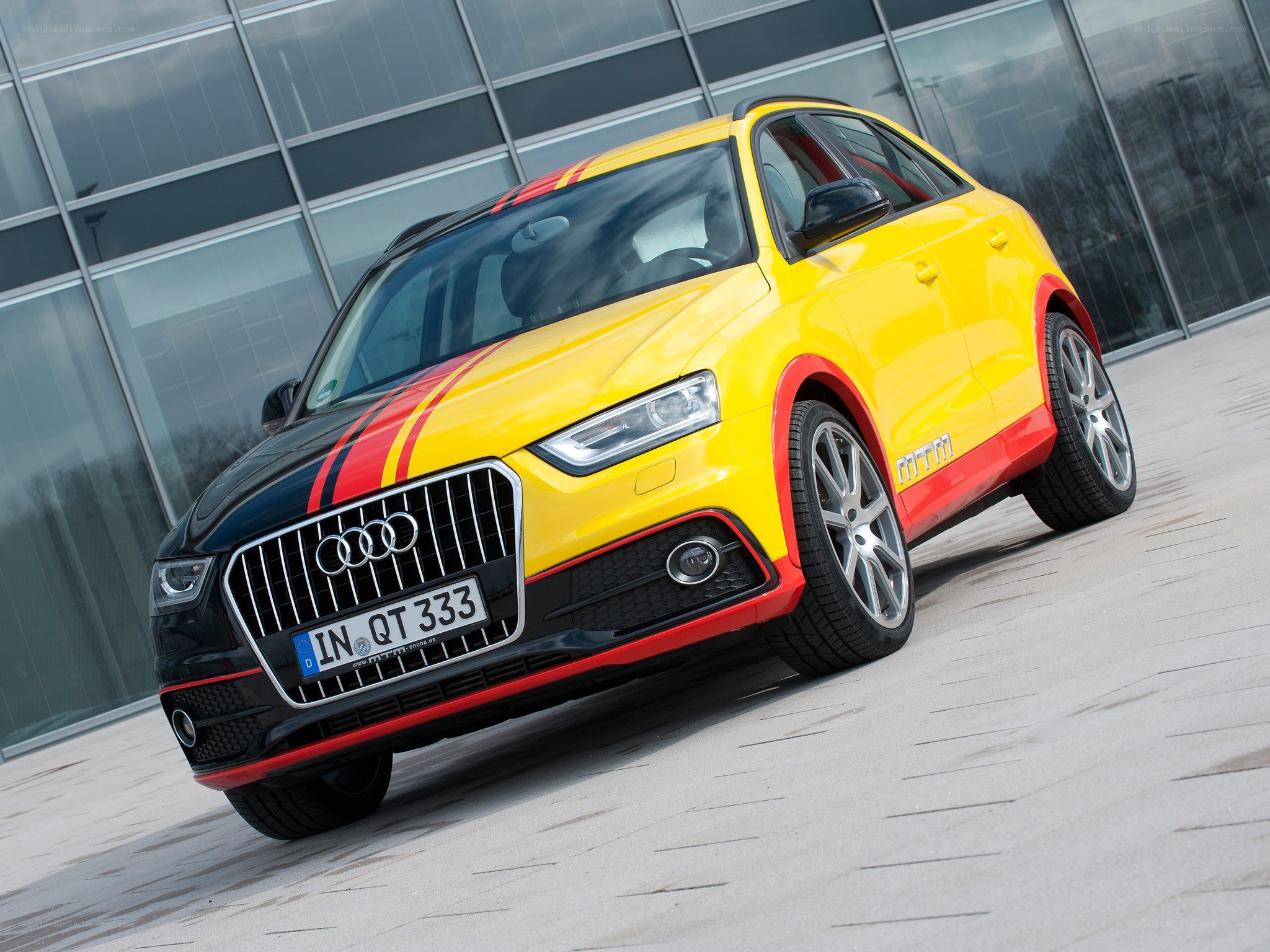 Yellow Audi Q3 with racing stripes