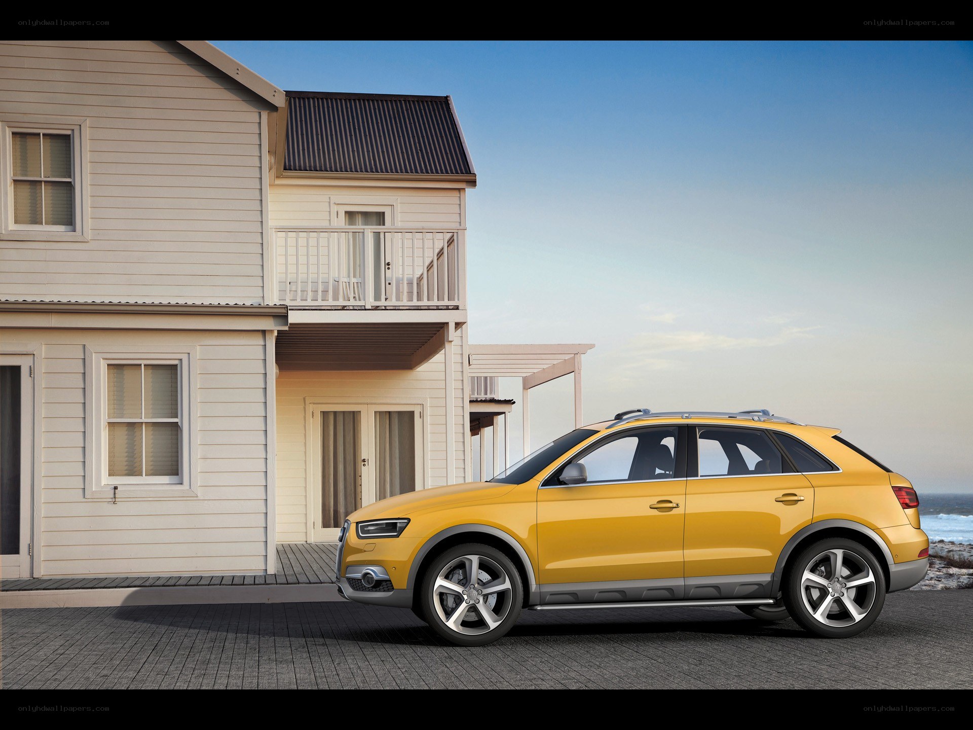 Yellow Audi SUV by beach house