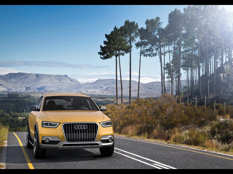 Yellow Audi SUV on a scenic road