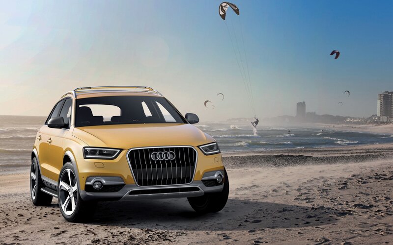 Yellow Audi SUV on beach