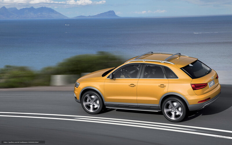 Yellow Audi SUV on coastal road