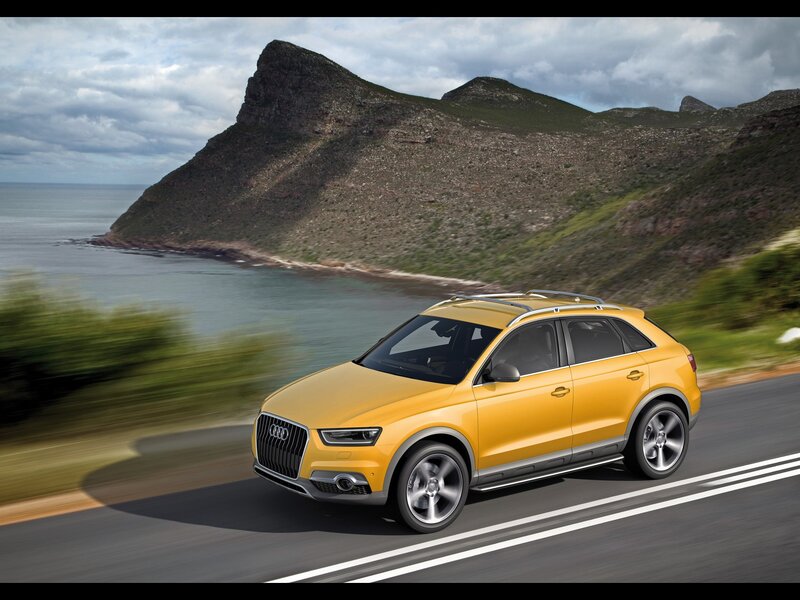 Yellow Audi SUV on coastal road