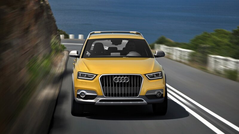 Yellow Audi SUV on coastal road