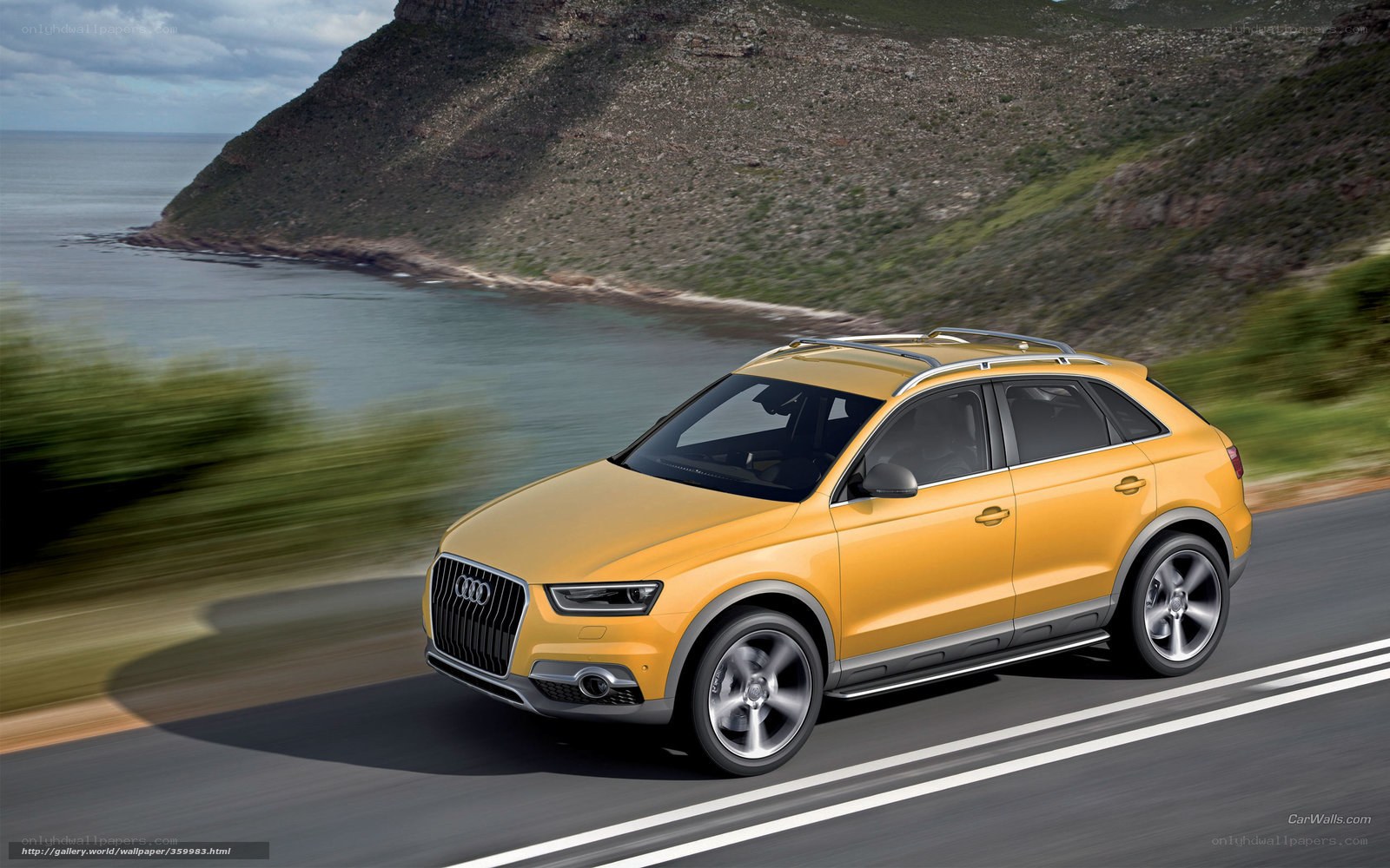 Yellow Audi SUV on coastal road
