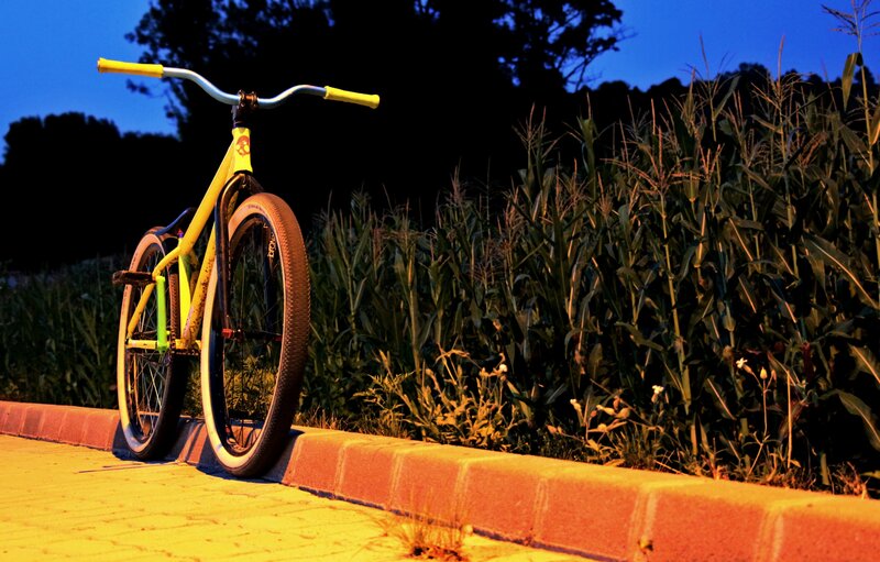 Yellow Bicycle on Curb — Dramatic