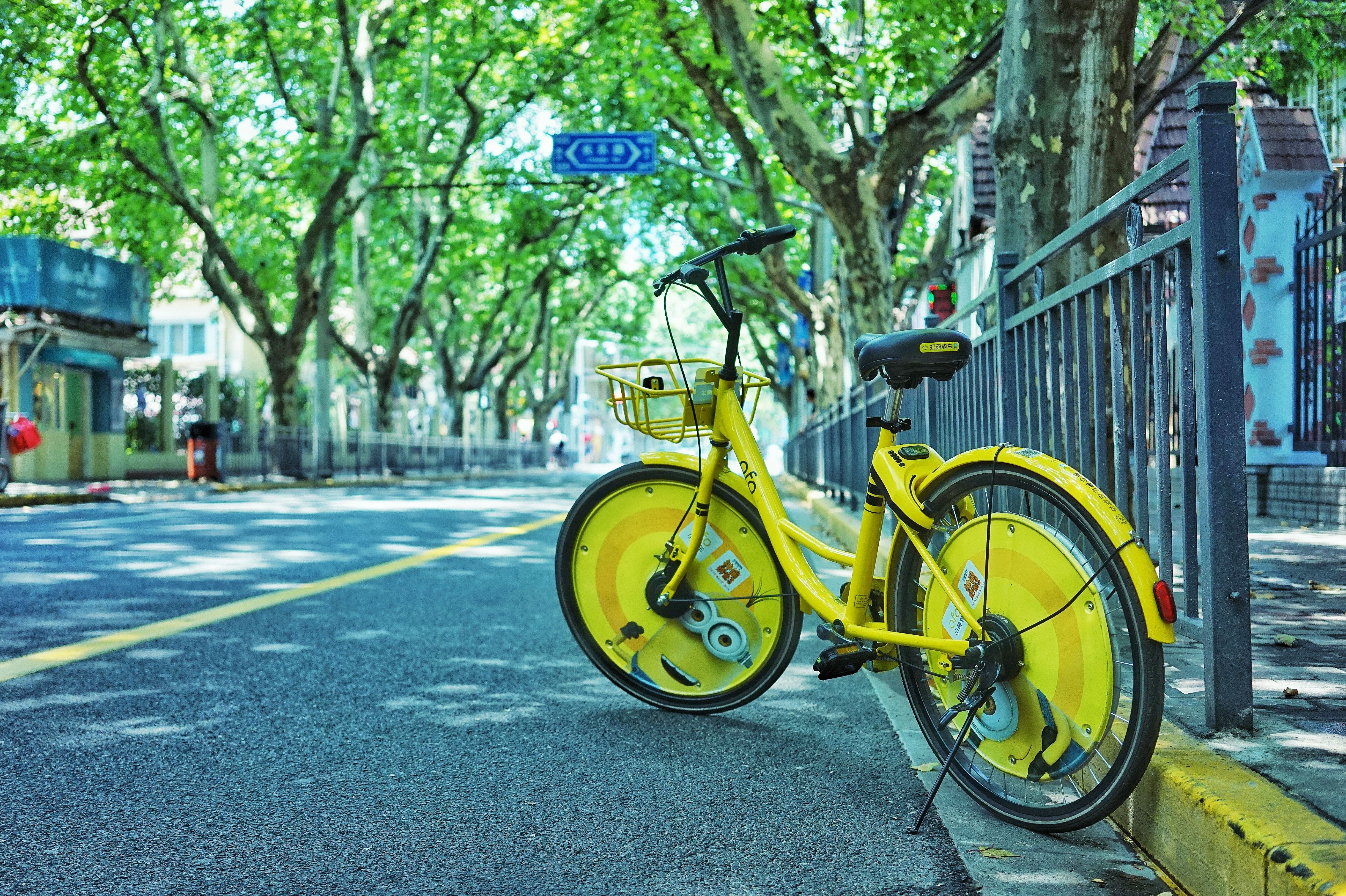 Yellow bike on a tree-lined street