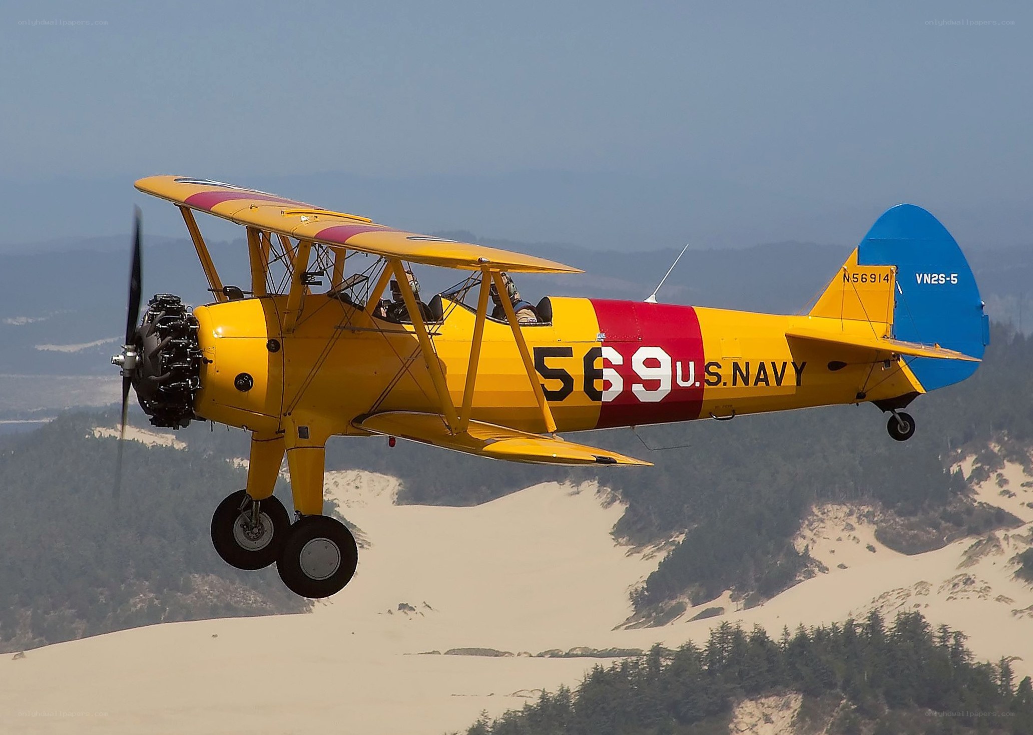 Yellow biplane in flight