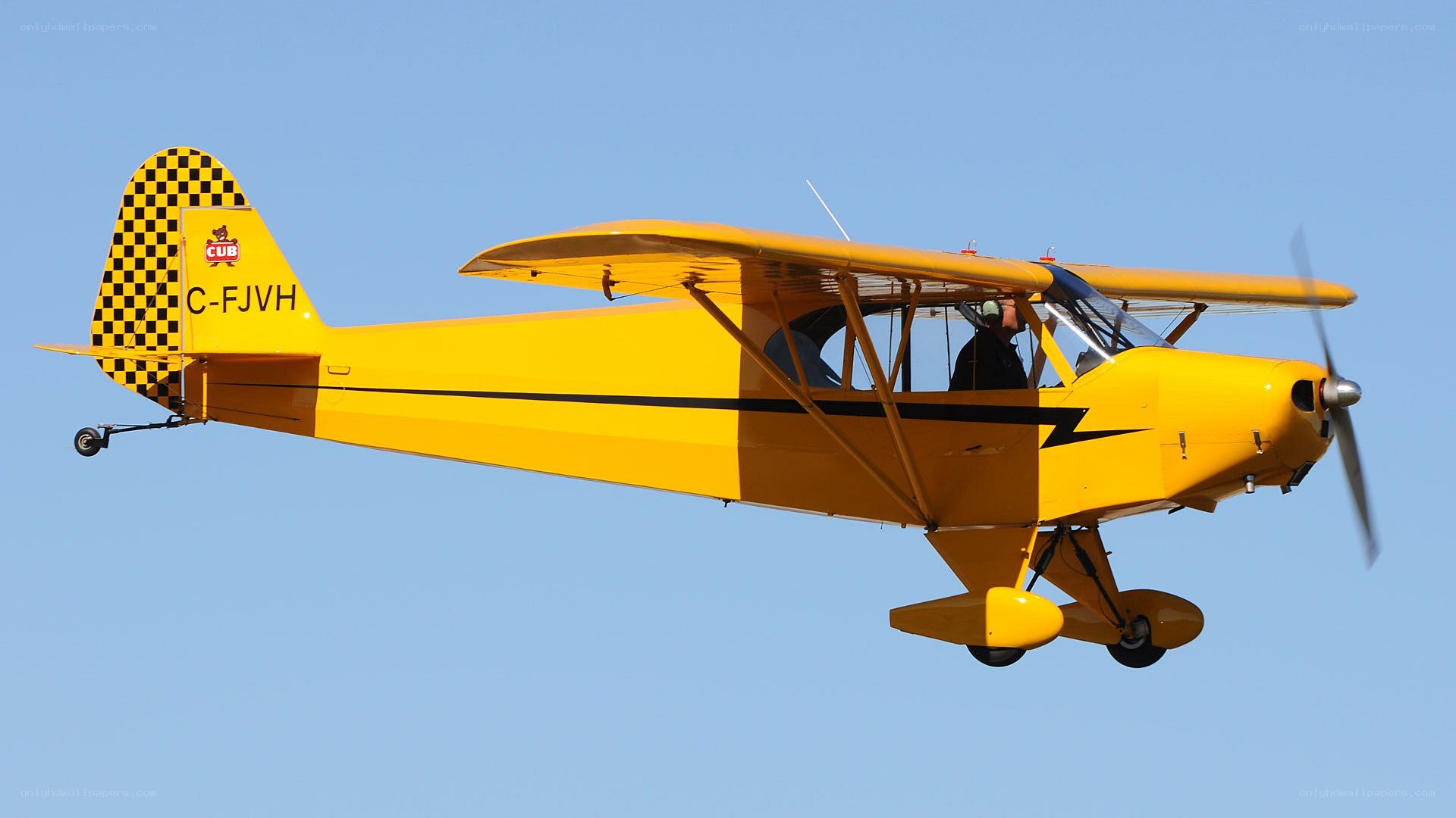Yellow biplane in flight