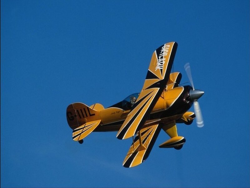 Yellow Biplane in Flight — Blue, Dynamic, Afternoon