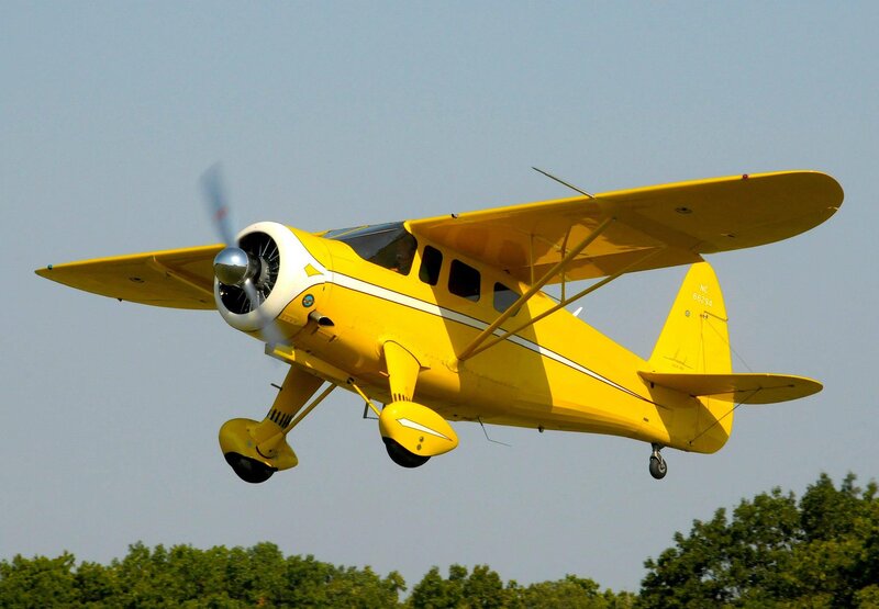 Yellow Biplane in Flight — Calm, Afternoon, Photograph