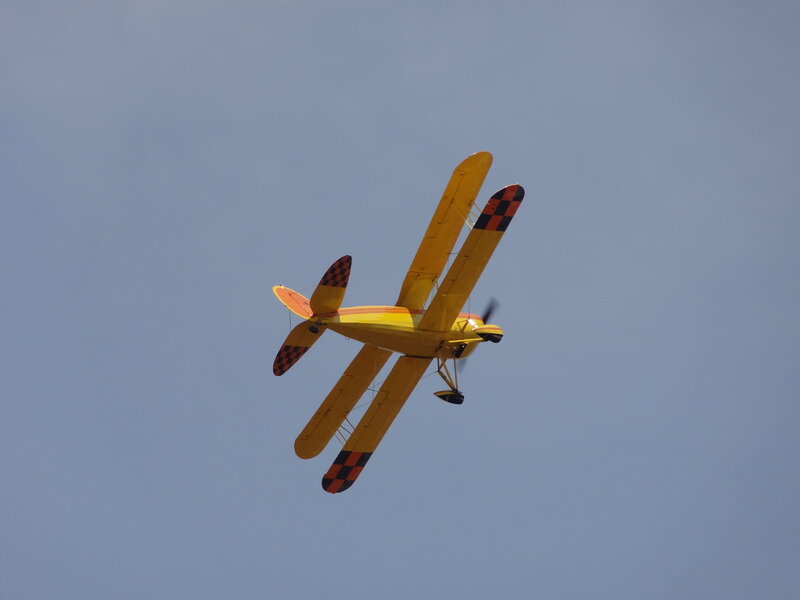 Yellow Biplane in Flight — Calm, Afternoon