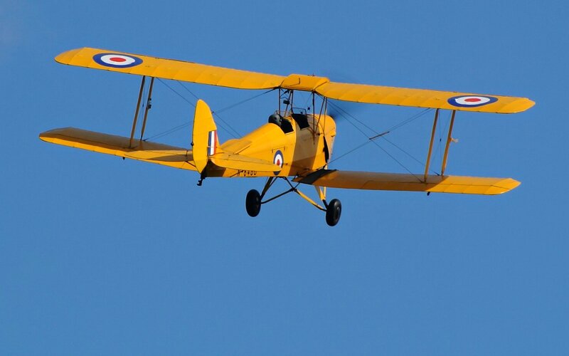 Yellow Biplane in Flight — Clear, Afternoon