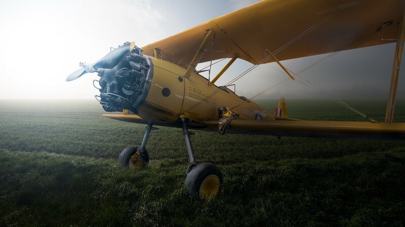 Yellow Biplane on Field