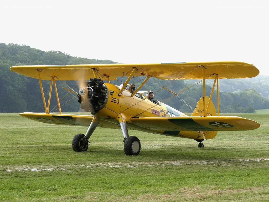 Yellow biplane on grass field
