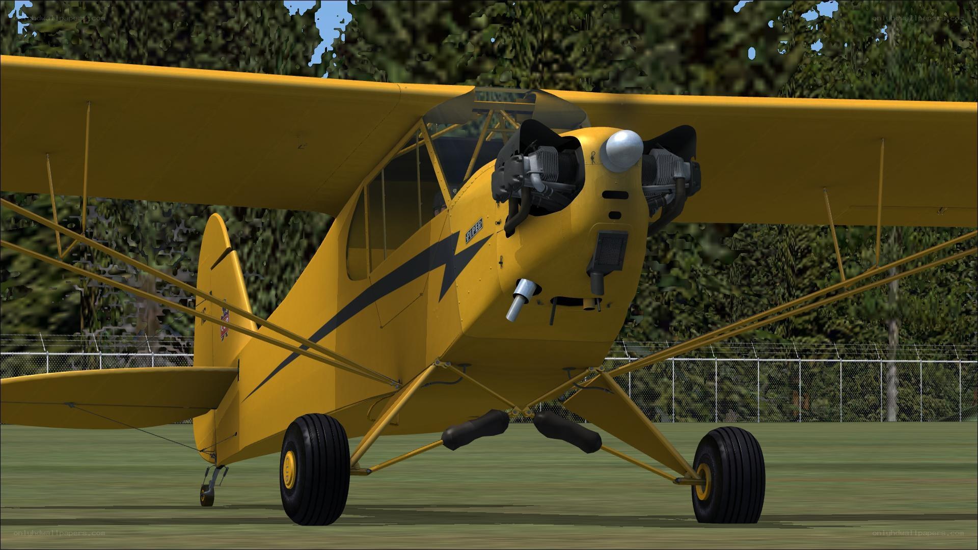 yellow biplane on grass